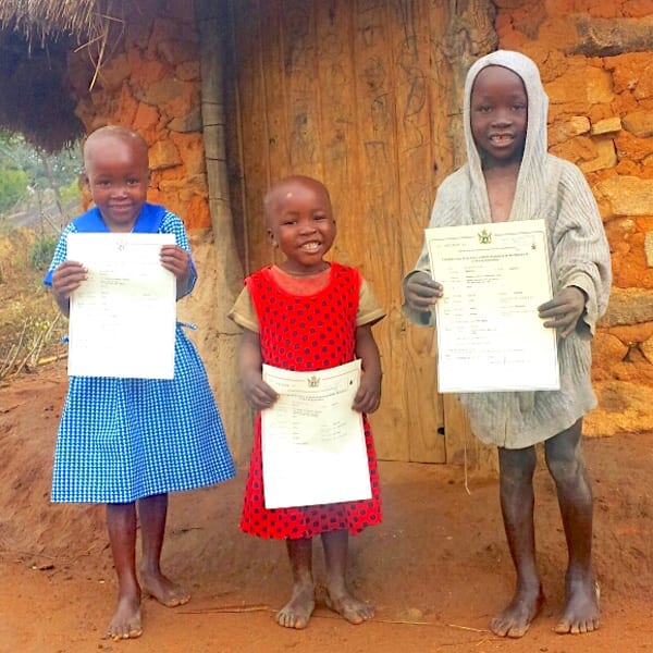 Three children with birth certificates